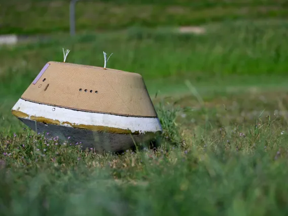 A replica of the sample return capsule sitting in the grass at Lockheed Martin in Littleton, Colorado