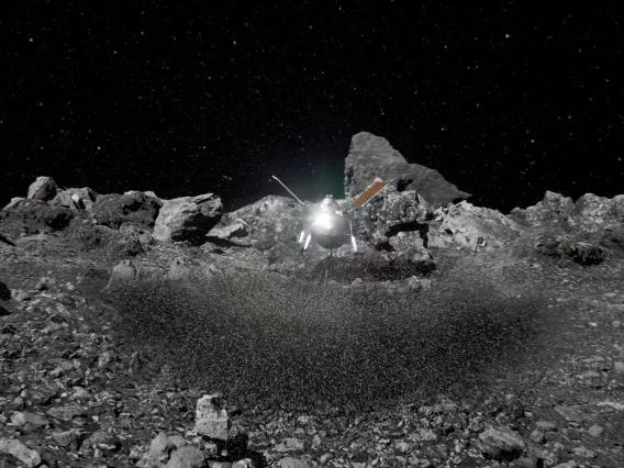Artist's impression of the OSIRIS-REx spacecraft kicking up rocks during sample collection on asteroid Bennu's surface